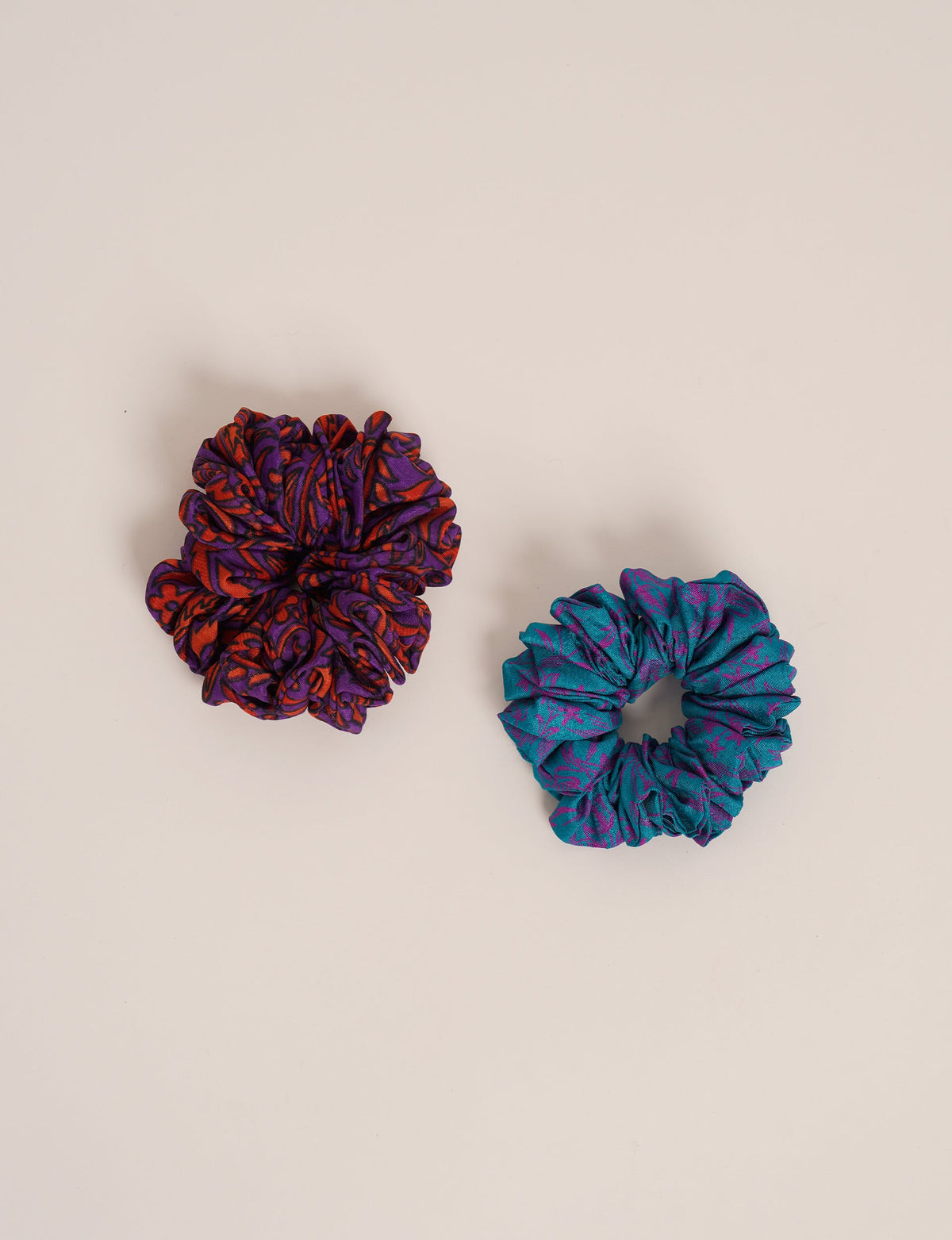 Upgrade your hairstyle with our Scrunchy Set of 2 – elastic hair ties wrapped in colorful Indian sari fabric. A top pick in ethical and green fashion, these eco-friendly prints add flair to your wrist and hair, making a sustainable style statement that catches attention and sparks change.