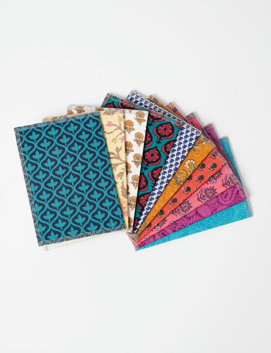Sustainably crafted FOLDED POSTCARD SET, 10 assorted pieces made with 100% recycled paper and printed sari fabric sourced from Mumbai markets. Eco-friendly with contrast overlock edging. Envelopes included for eco-conscious gratitude and cheerful messages to loved ones.